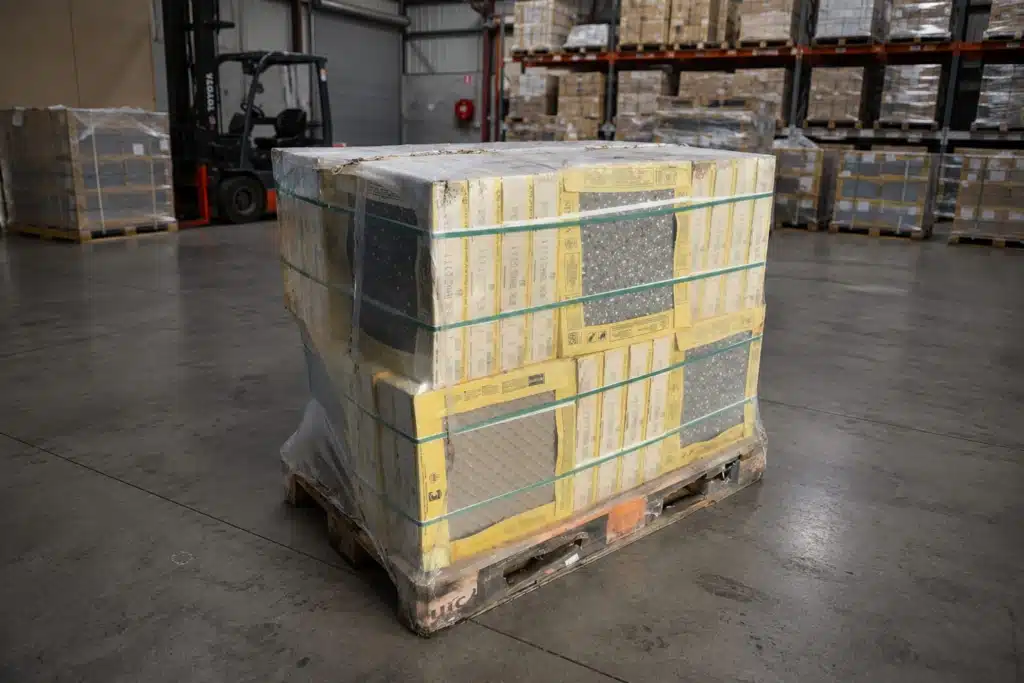 Strapped Tile Pallet in the Warehouse Pallet of boxed tiles secured with straps in the warehouse