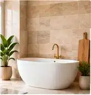 Warm almond travertine-look wall tiles behind a freestanding bath